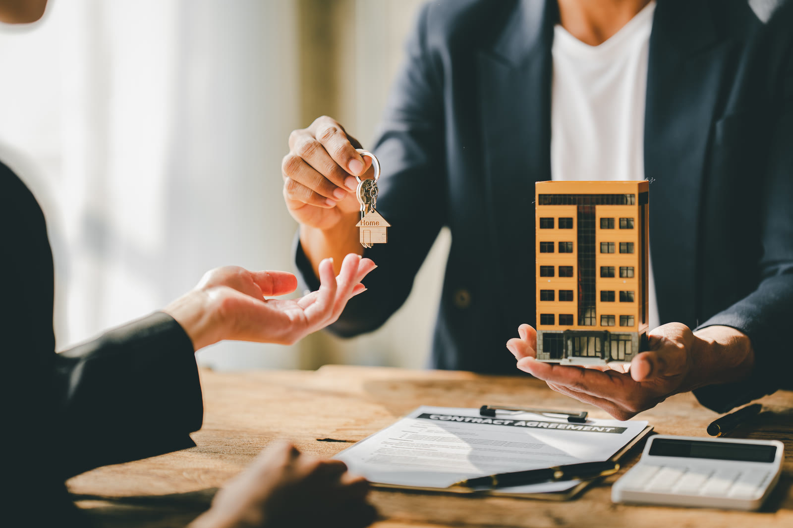 House keys being handed from one person to another